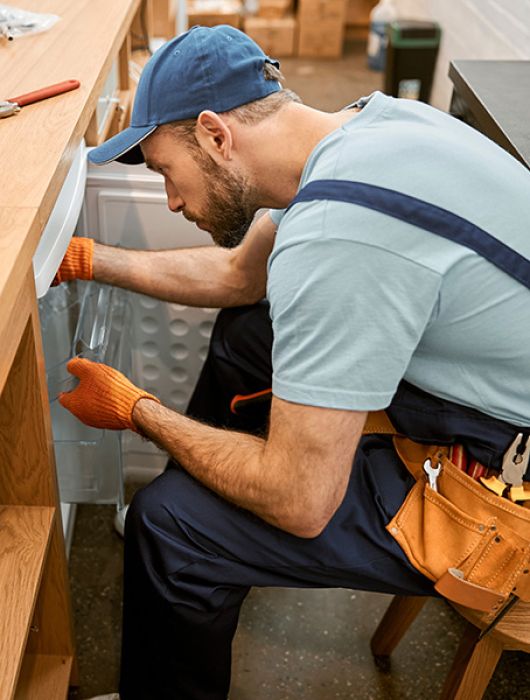 carpenter installing refrigerator
